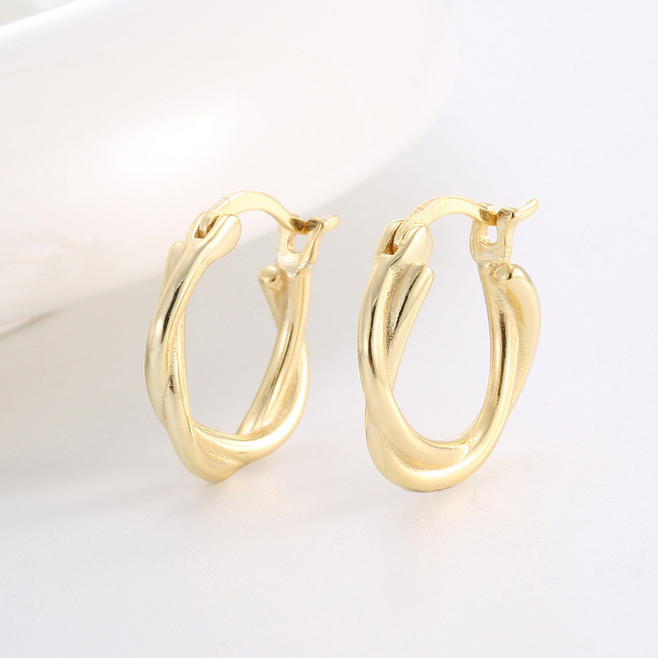 angled pair of sculptural 925 silver double-line hoop earrings