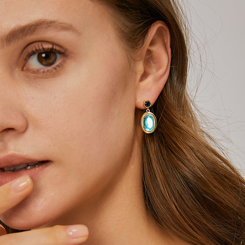blue glass cabochon drop earrings worn with post backs