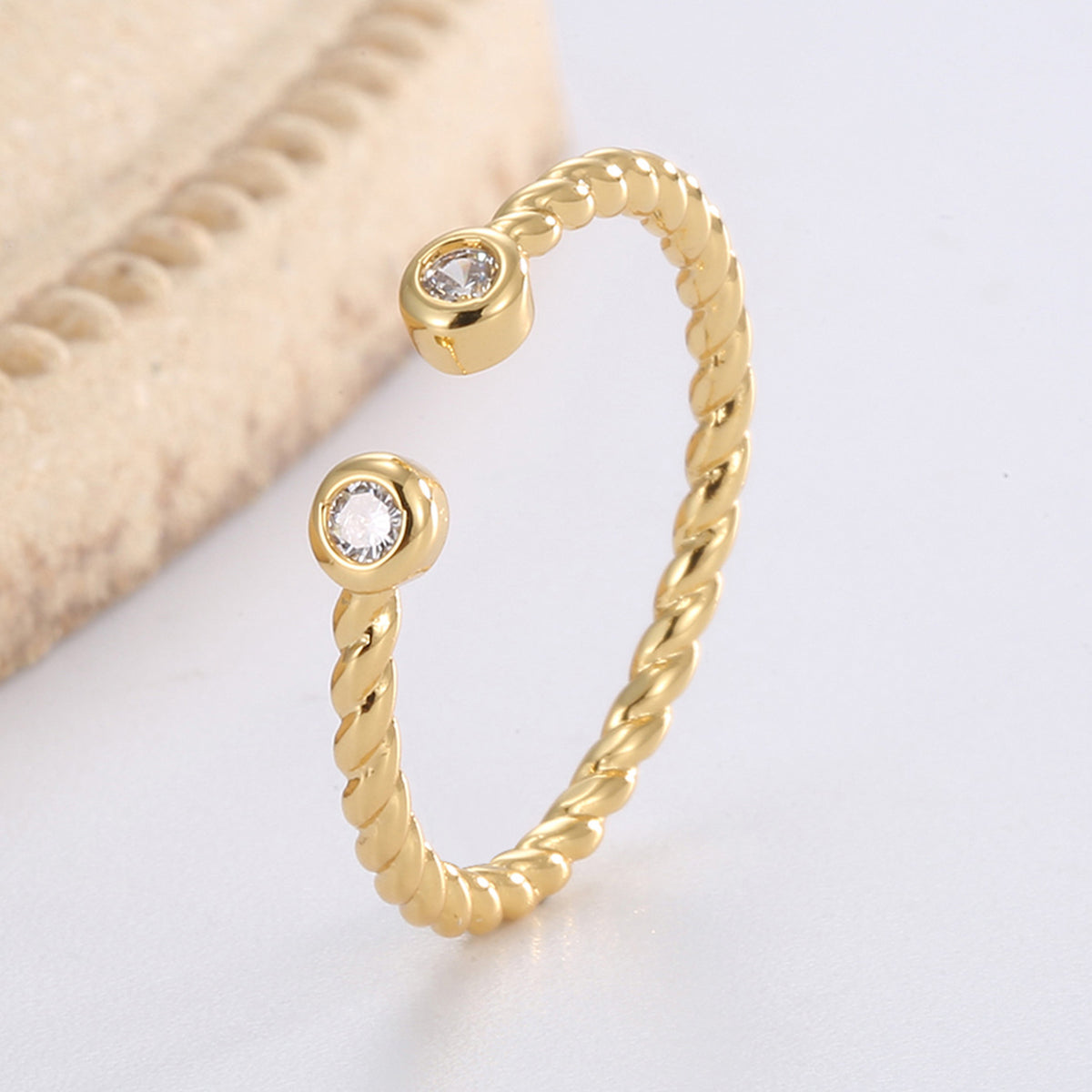 upright view of twin bezel zirconia stones on a rope-twist band