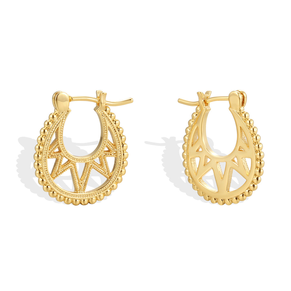angled pair of textured brass openwork hoop earrings