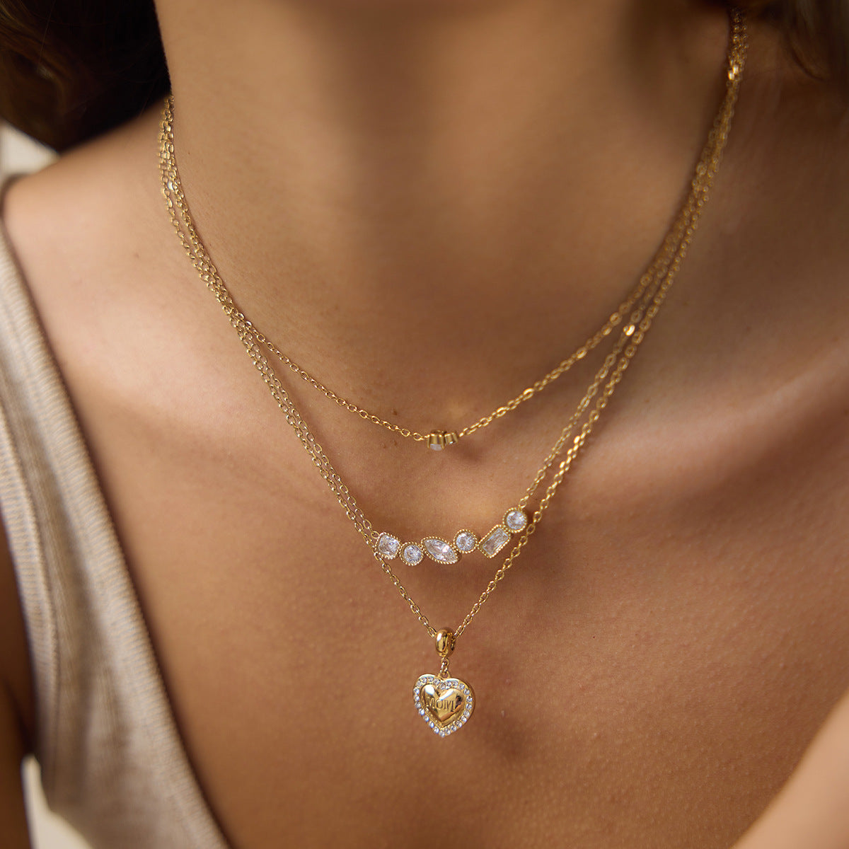 Clear stone cluster necklace layered with separate necklaces