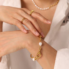 close wrist view of chunky oval-link and pearl bracelet