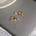 Round-accent huggies with pear drops on a table