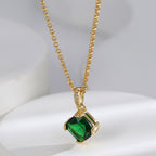 angled close view of green faceted stone and clear-accent bail