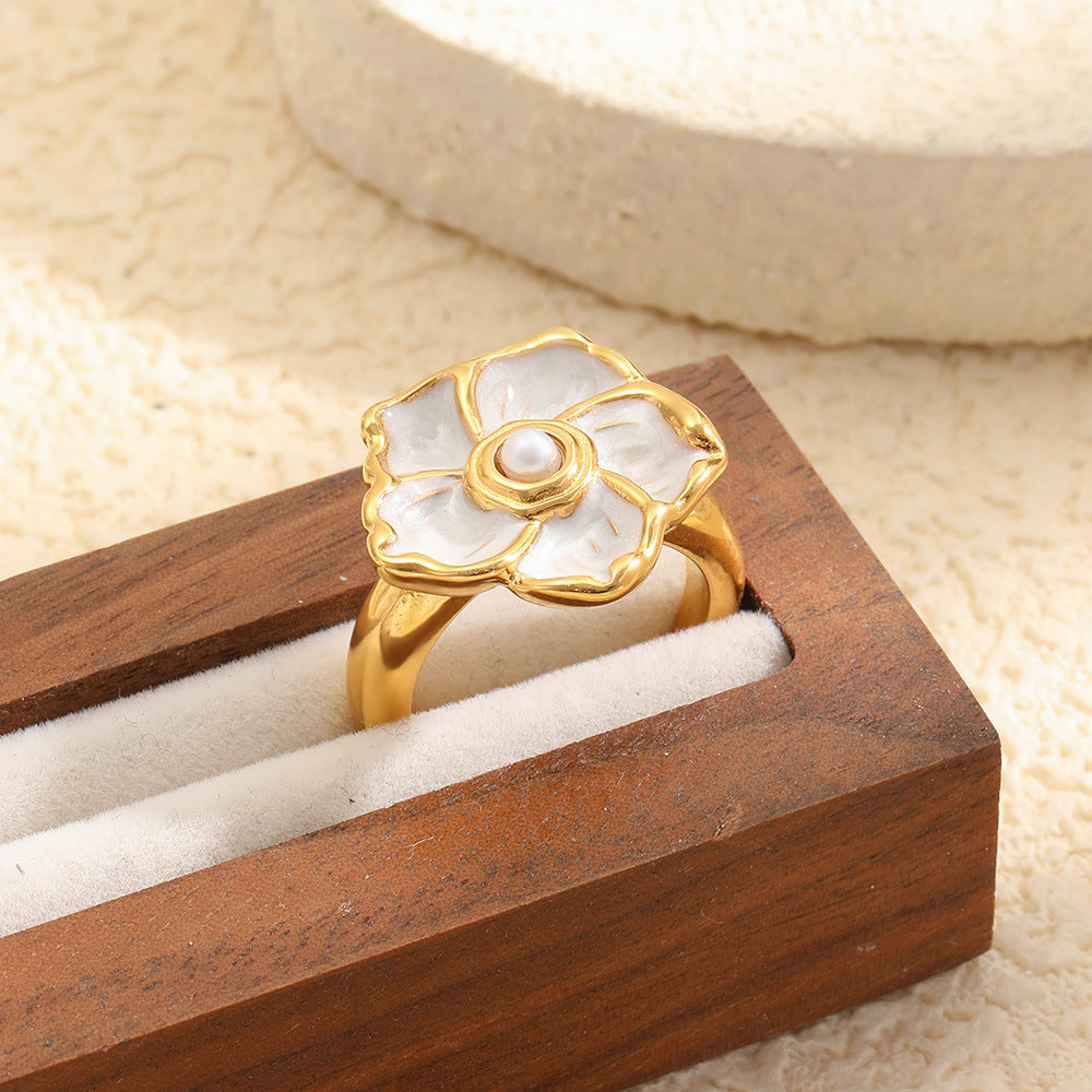 ivory flower ring displayed in a wooden jewelry box