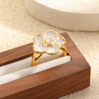 ivory flower ring displayed in a wooden jewelry box