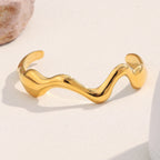 gold plated stainless steel sculptural wave open cuff bracelet