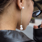 Glass pearl and clear stone long earring worn with sunglasses