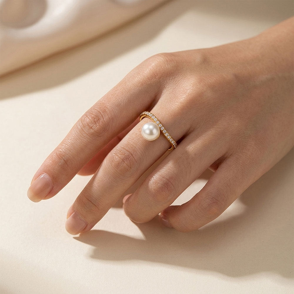 White pearl-look bead ring worn on a hand