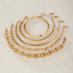Flat oval twin-bar and overlapping-link bracelets laid out