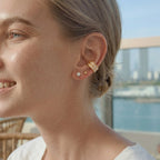 Gold-tone ear cuff styled with small studs