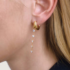 long clear stone drop huggie earring worn from the side