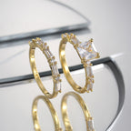 two-piece zirconia ring set standing on a mirrored surface