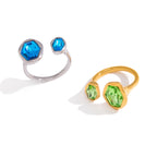 Two asymmetric open rings showing unequal stones