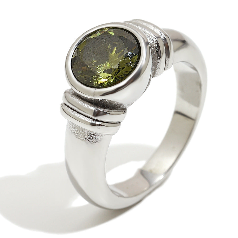 isolated silver-finish stainless steel ring with round green stone