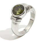 isolated silver-finish stainless steel ring with round green stone