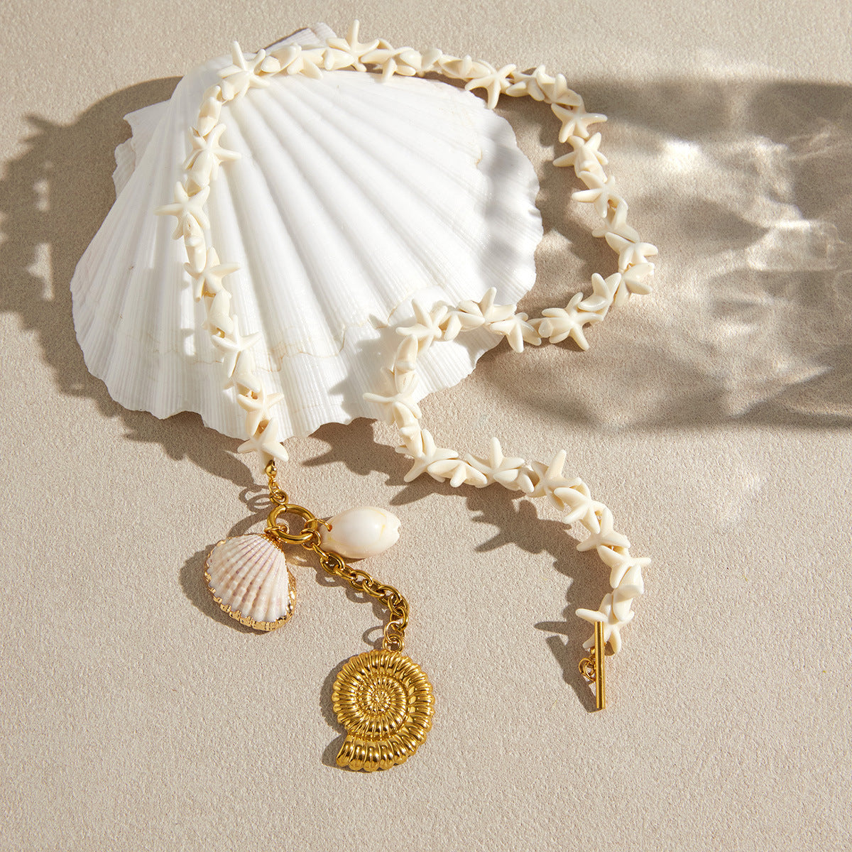 Starfish bead necklace arranged on a shell
