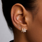 White flower and clear accent stud worn on an ear