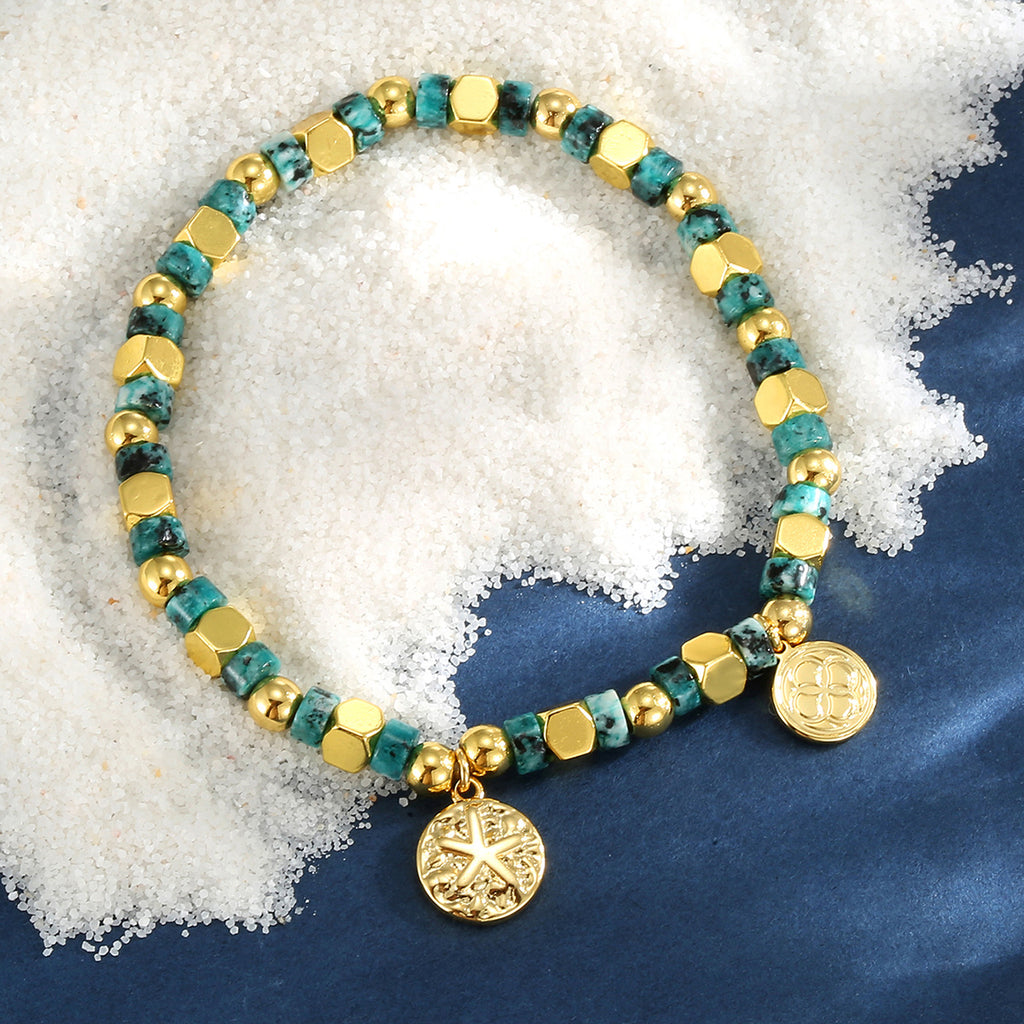 turquoise-color bead starfish bracelet on a blue display