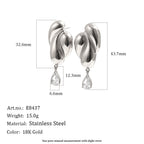Silver tone folded earrings with clear pear-shaped accents