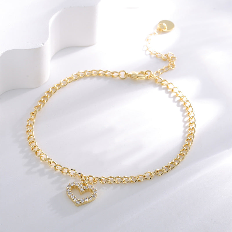 cubic zirconia heart charm anklet displayed on white blocks