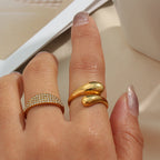 Double teardrop ring worn beside a separate stone-set band