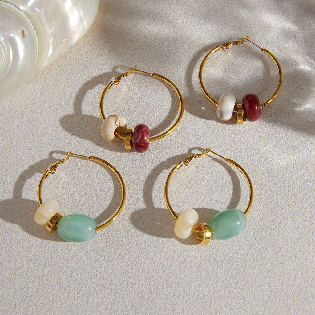 Two bead colorways on a pale fabric surface