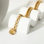 Bracelet draped over a stand showing extension and shell charm