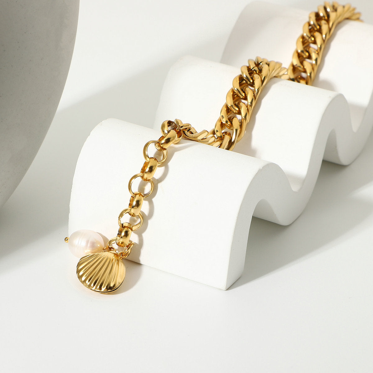 Bracelet draped over a stand showing extension and shell charm