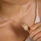 Oval portrait pendant shown close-up on model