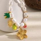 pearl-look bead necklace with large flower and colorful hanging charms