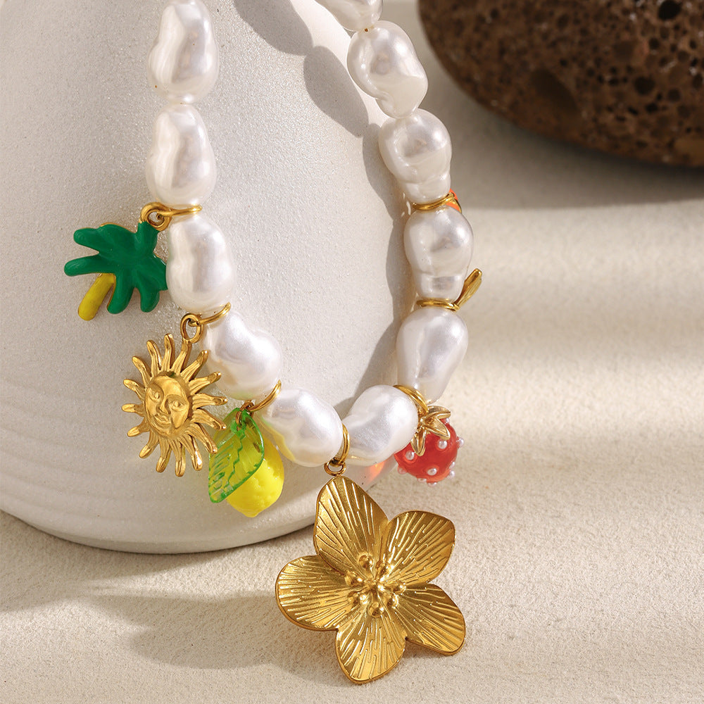 pearl-look bead necklace with large flower and colorful hanging charms