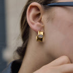 Gold-tone rectangular zirconia hoop shown on a model