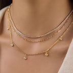 Triple layer stone charm necklace close-up at neckline