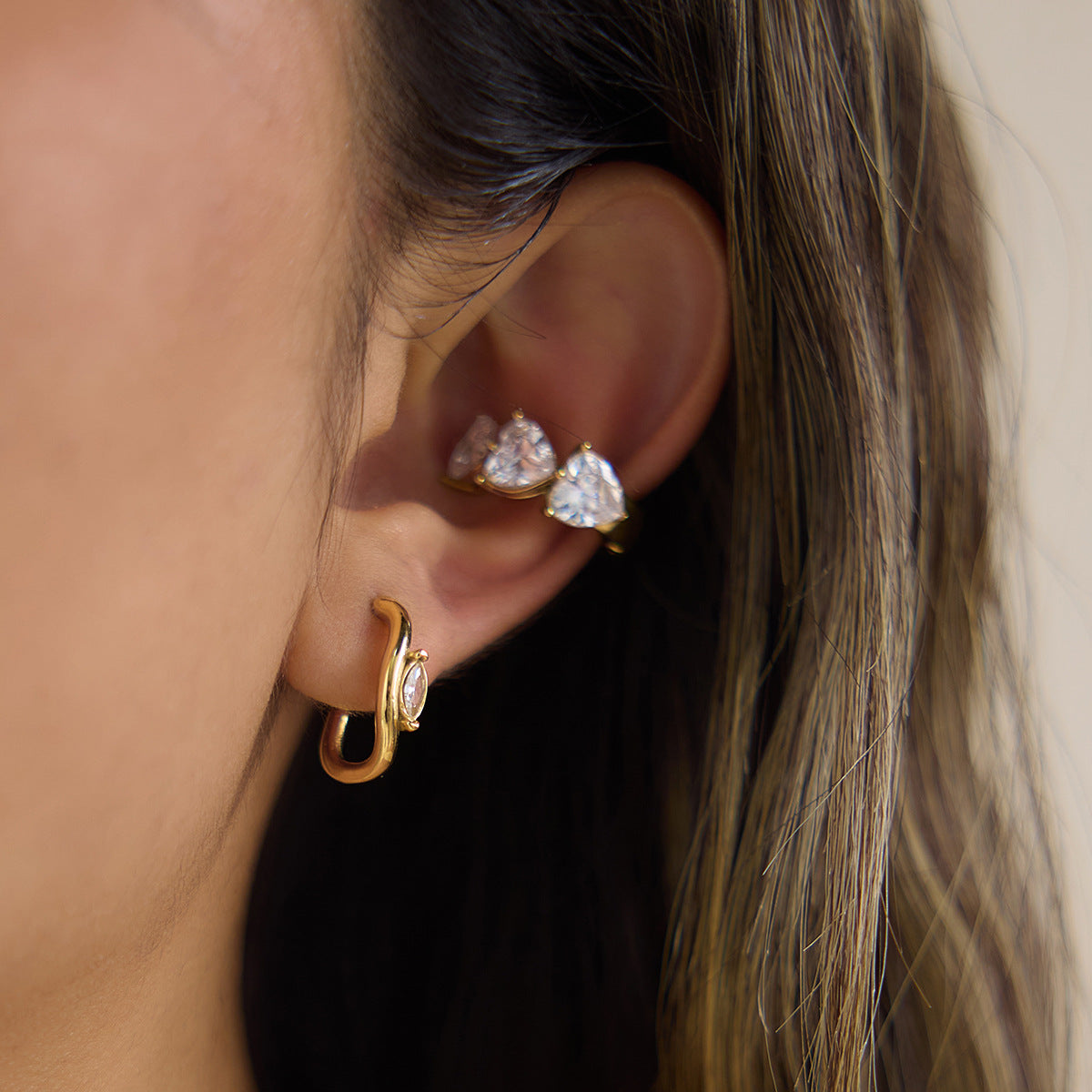 Open hoop styled below separate clear stone studs