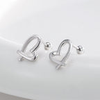 pair of open ribbon-heart ball-back earrings in an angled view