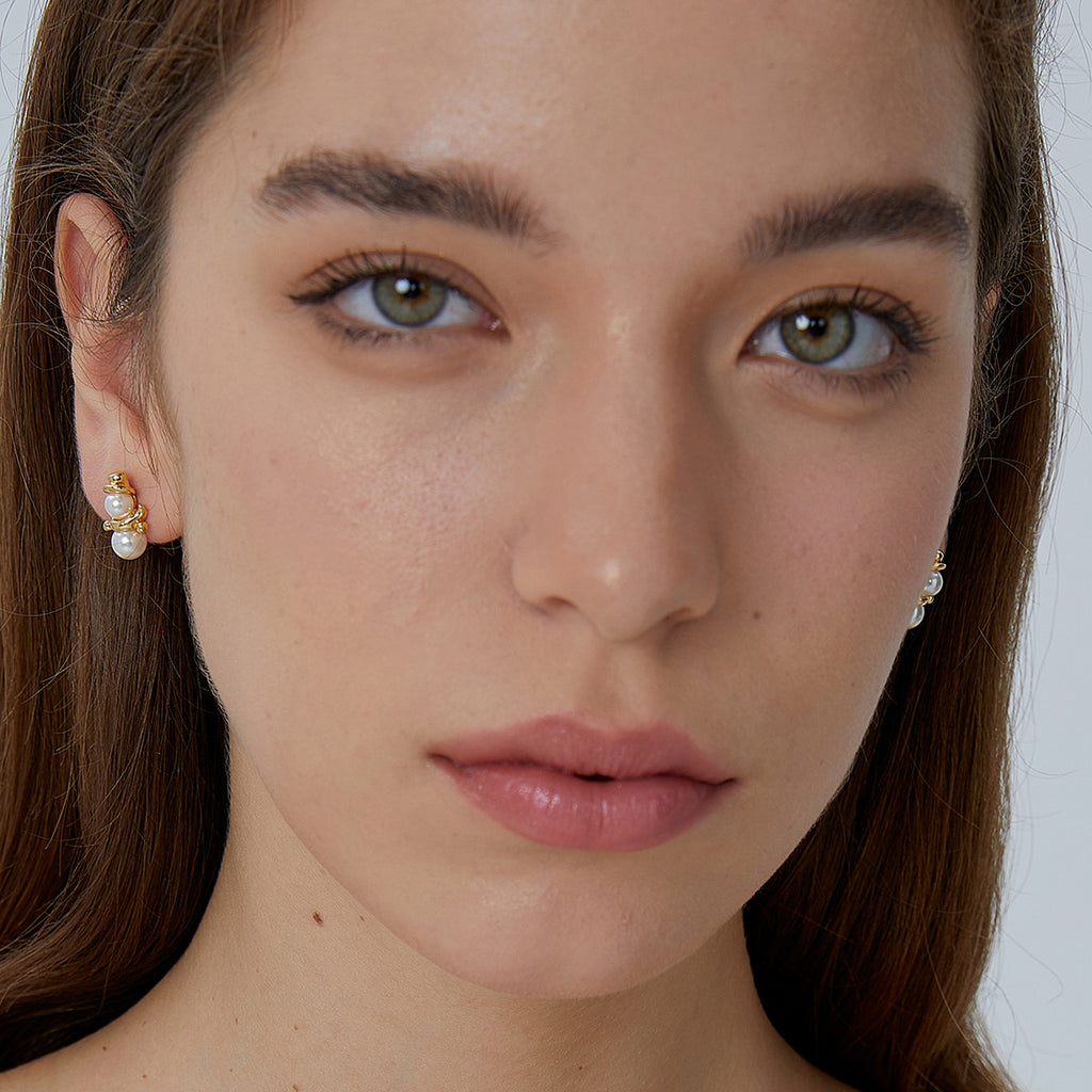shell pearl snowman stud earrings worn on the earlobe