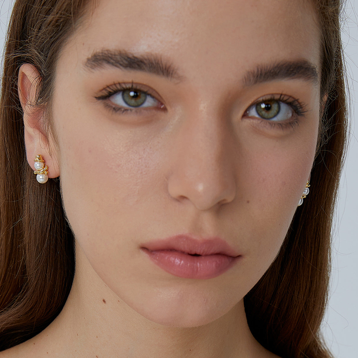 shell pearl snowman stud earrings worn on the earlobe