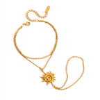 Gold-tone sun hand chain on white