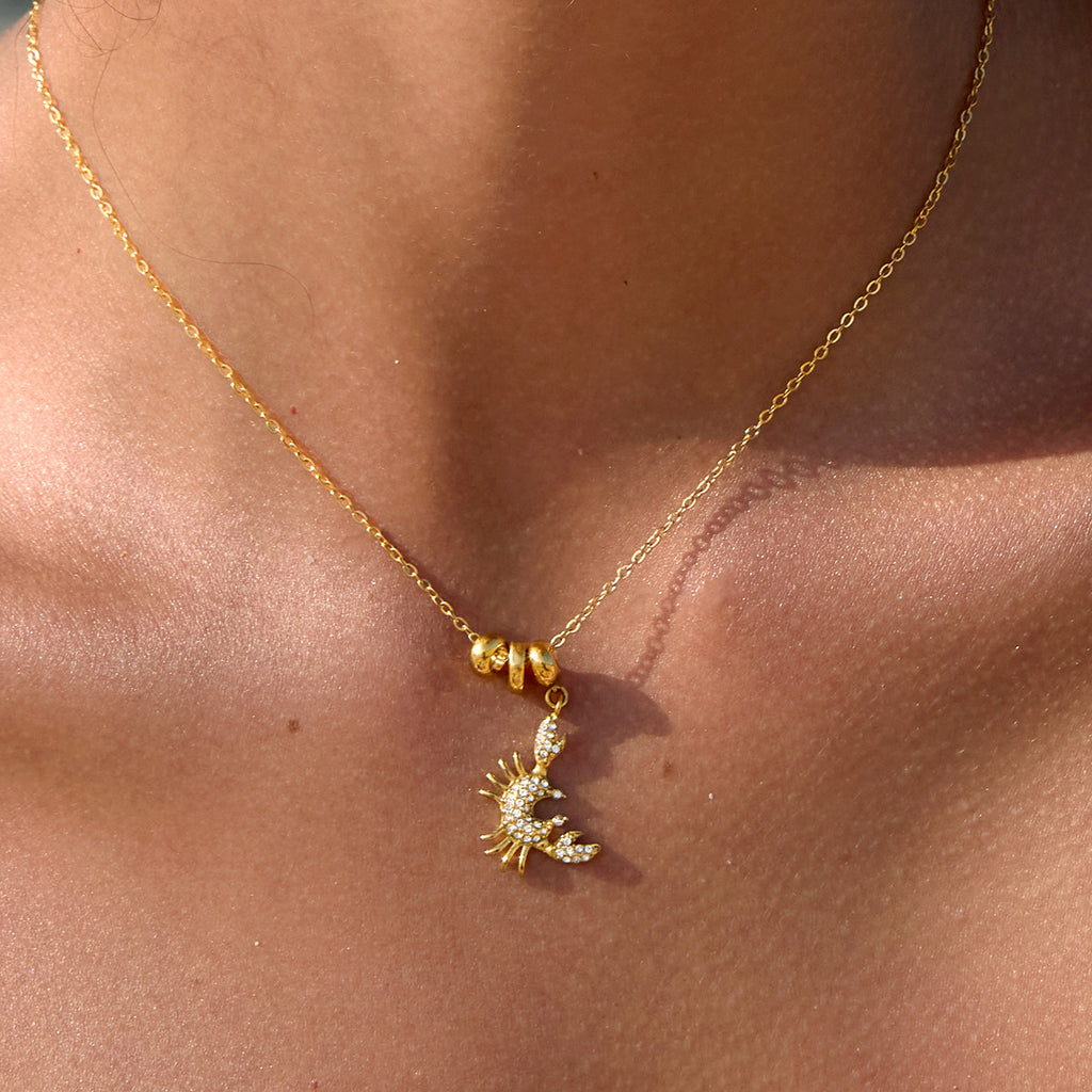 Crab pendant necklace with gold-tone beads