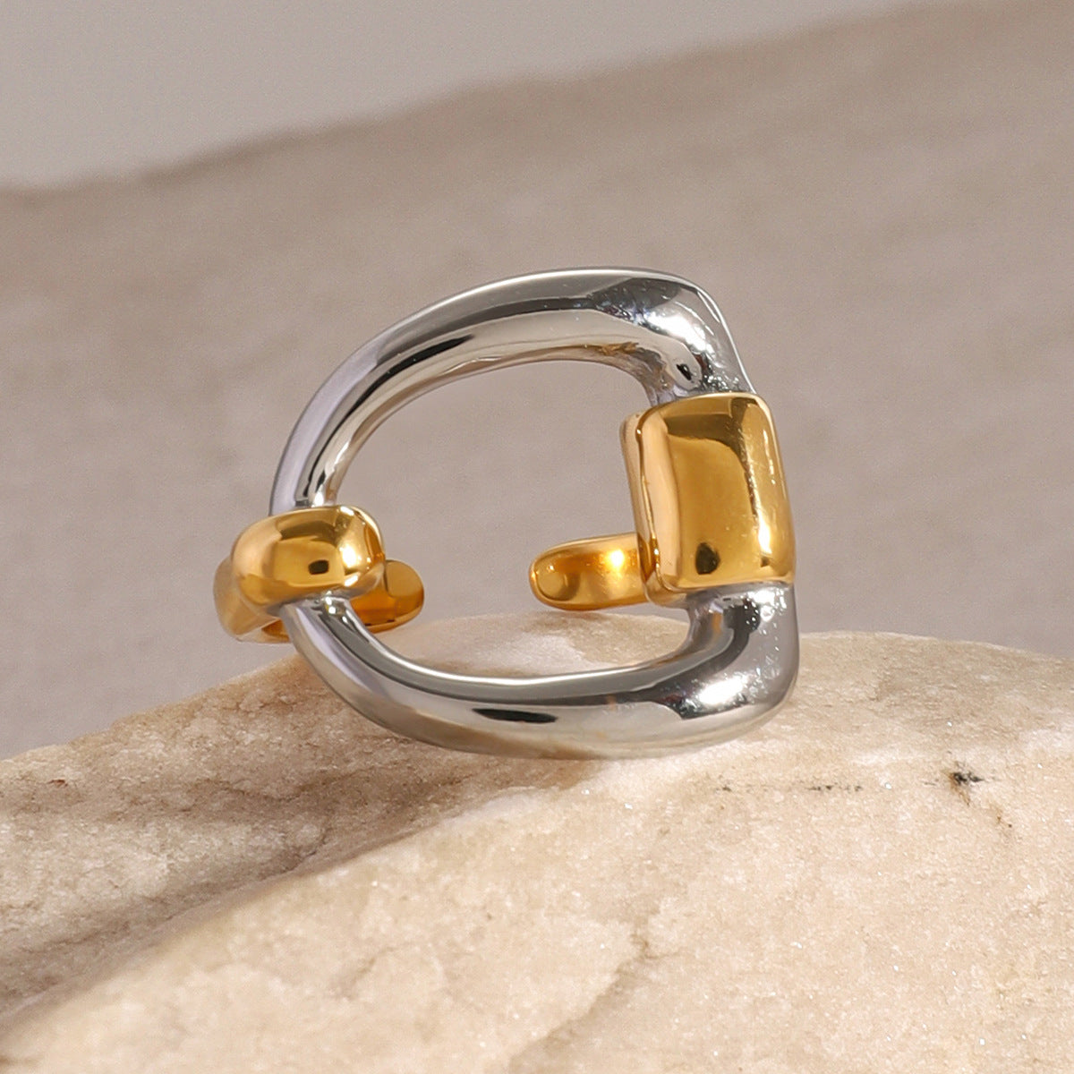 Front view of the silver-tone square and gold-tone supports