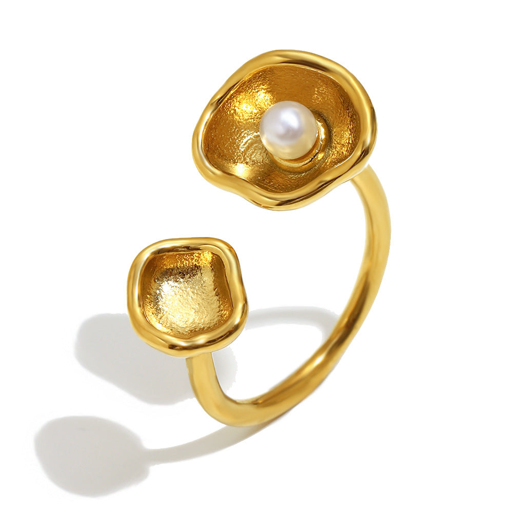 isolated gold plated open ring with white pearl in a shell cup