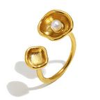 isolated gold plated open ring with white pearl in a shell cup