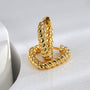 pair of gold plated twisted heart hoop earrings standing upright