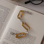 Mixed-tone stainless steel bracelet on an open book