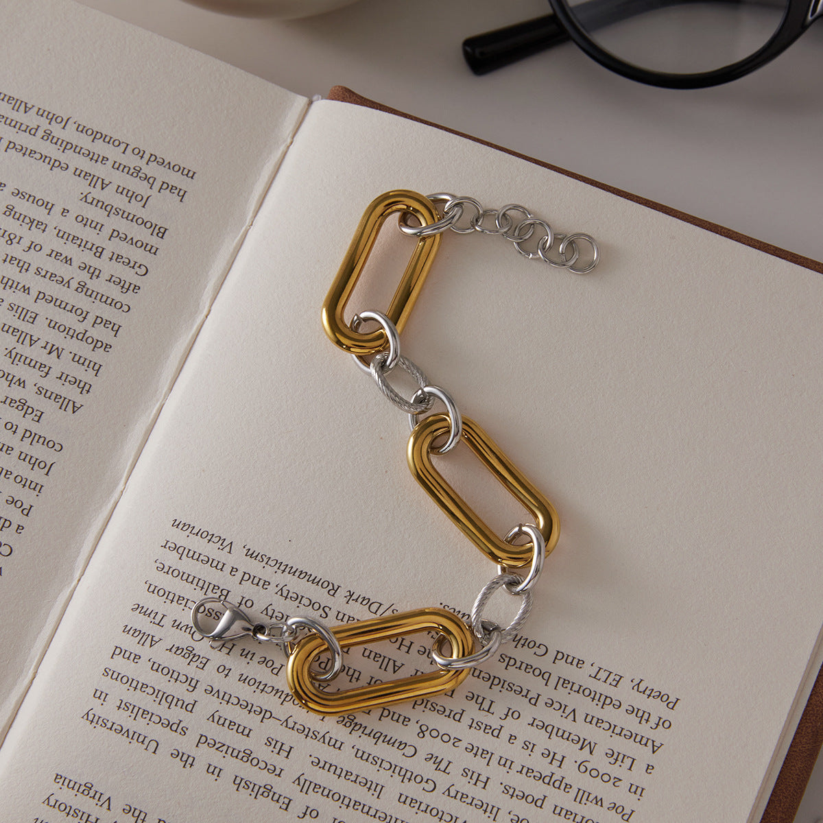 Mixed-tone stainless steel bracelet on an open book