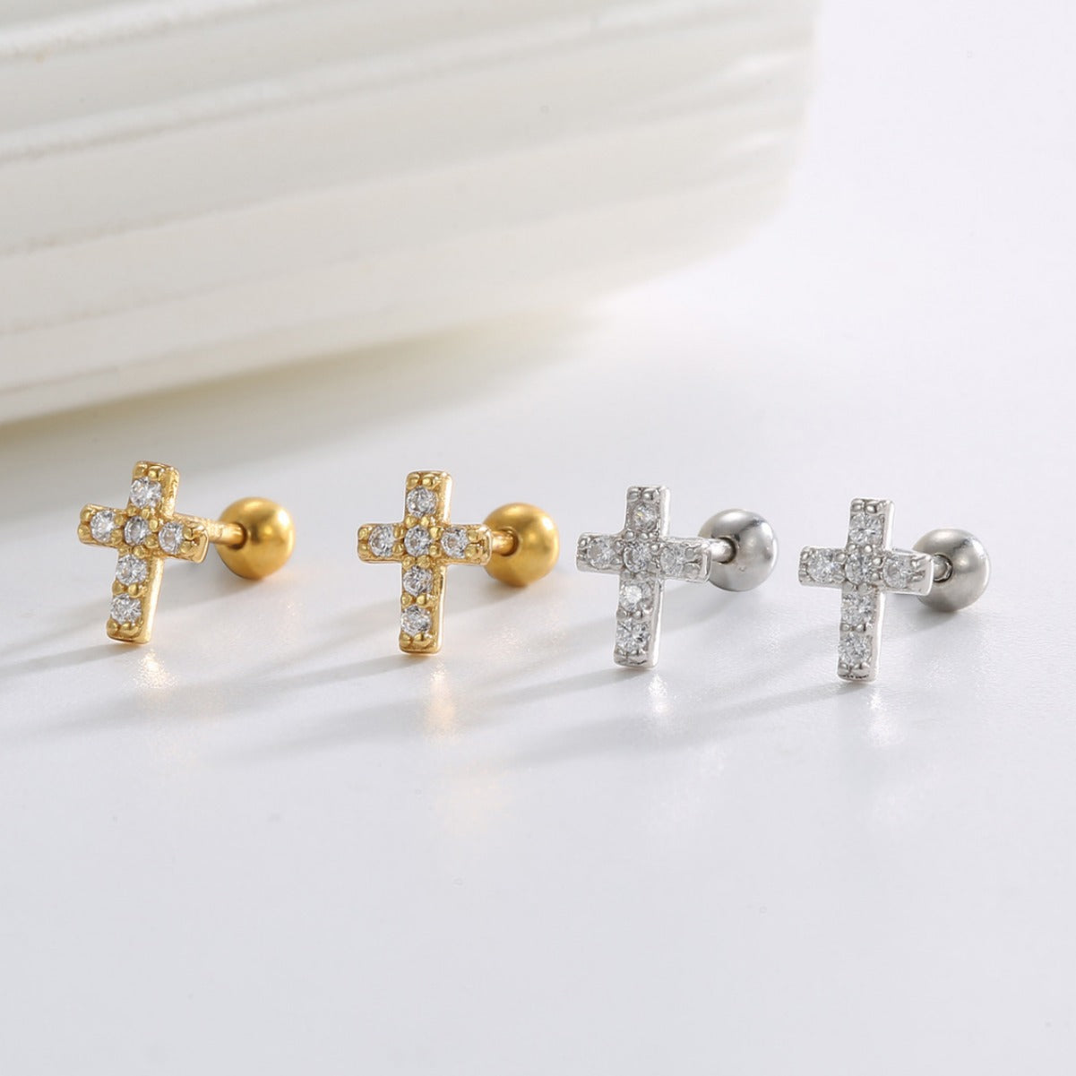 925 Sterling Silver Pavé Cross Ball-Back Stud Earrings — gold and silver pairs on white ledge