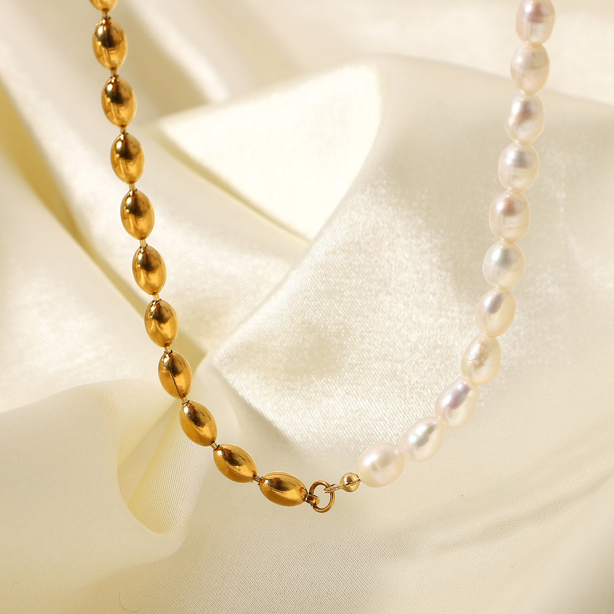 Half white bead half gold bead necklace in a styled display