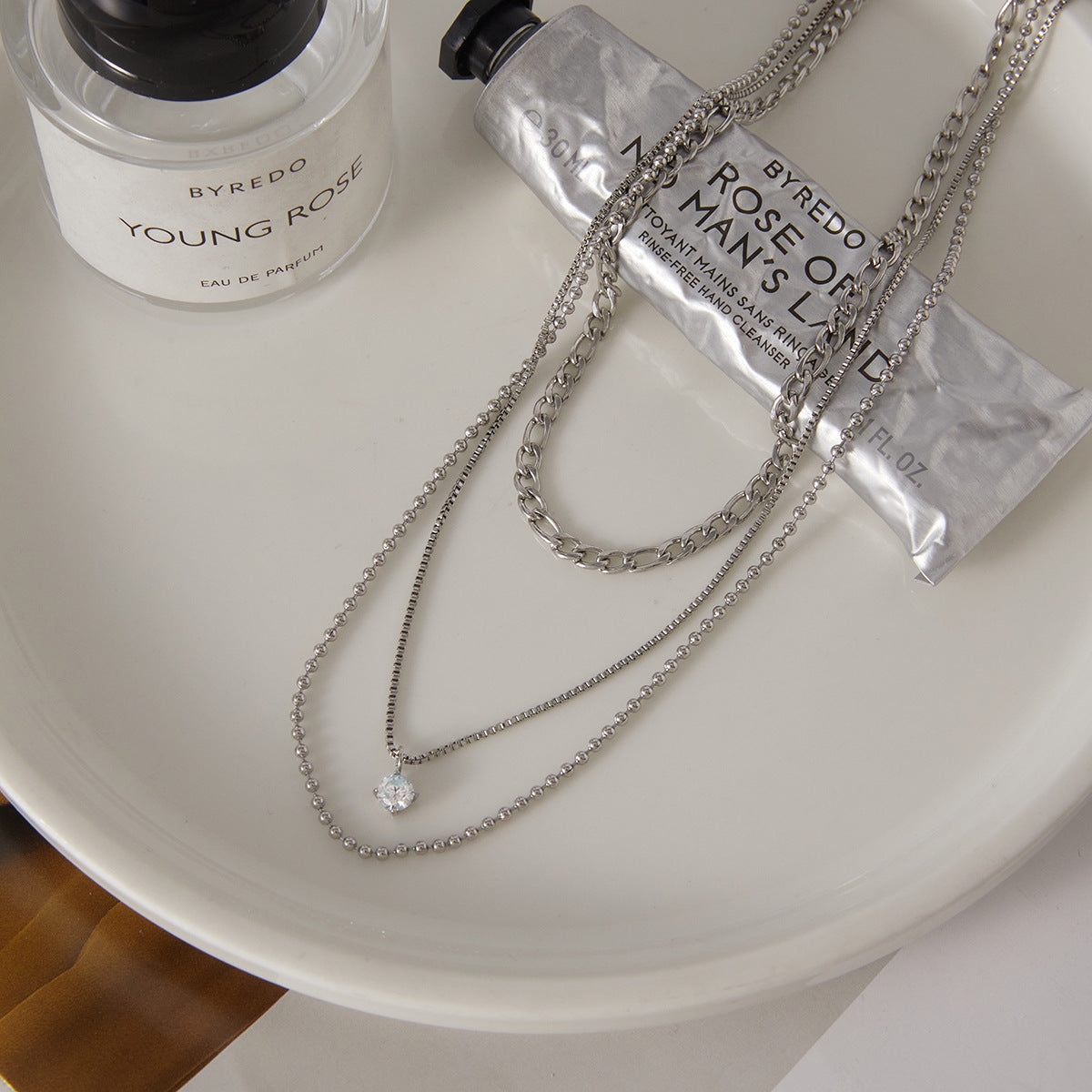 silver-finish layered necklace with small clear faceted pendant
