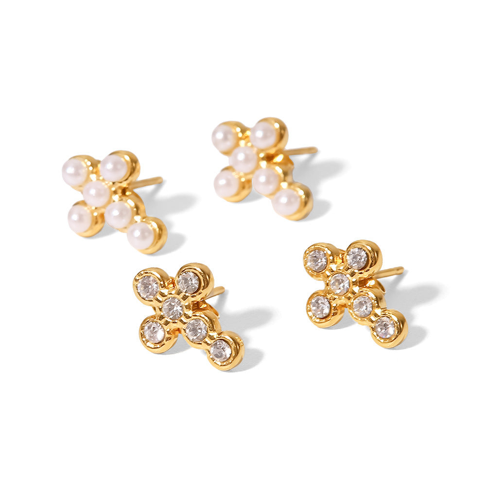 Pearl-look and clear accent cross stud earrings on white